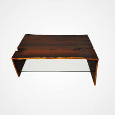 Its frame is crafted from metal in a versatile black. Raw Edge Cocobolo Coffee Table Glass Shelf Rotsen Furniture