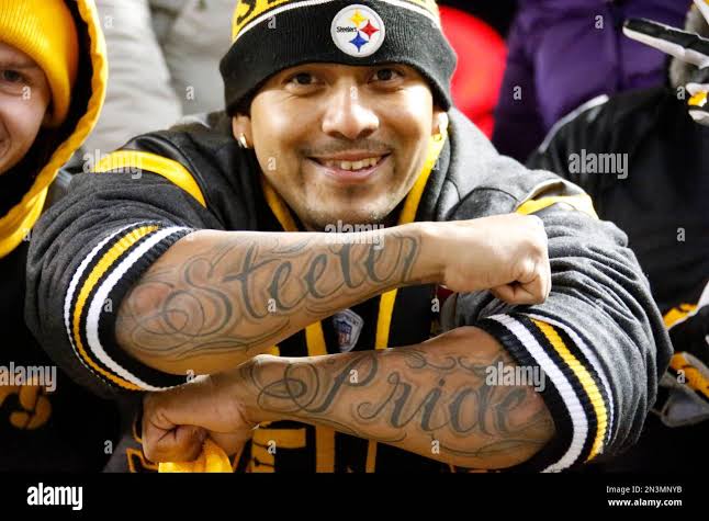 A Pittsburgh Steelers fan shows his tattoos as the teams warm up before an  NFL football game against the Baltimore Ravens, Sunday, Nov. 2, 2014, in  Pittsburgh. (AP Photo/Gene Puskar Stock Photo -