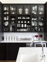 At Home Arkansas Kitchen Black Cabinets Glass Doors Marble Counters Via Cococozy Jpg 601 800 Pixels Black Kitchen Cabinets Dark Kitchen Cabinets Dark Kitchen