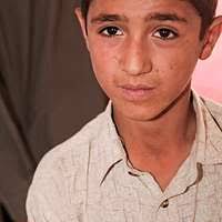 Members of Arbakai listen as Mohammed Ullah, the leader