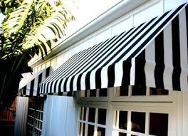 Black And White Striped Retractable Awning Black And White Striped Awnings On A White House Dark Grey Door House Exterior White Windows Window Awnings
