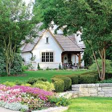 The exterior has a mix of shake, board and batten, arched gables and porches giving it a true fairy tale cottage look and feel. This Cottage Is Straight Out Of A Fairy Tale Cottage Journal