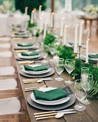 A Wedding Table Decorated With Tableware Greenery And Dark Green Napkins Green Wedding Colors Wedding Reception Tables Green Napkins