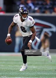 Baltimore Ravens Quarterback Lamar Jackson Rolls Out To Pass In An Lamar Jackson Baltimore Ravens Football Ravens Football