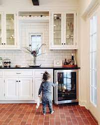 Amazing gallery of interior design and decorating ideas of red brick kitchen floor in home exteriors, decks/patios, dens/libraries/offices, laundry/mudrooms, kitchens, porches, basements by elite interior designers. Kitchen Flooring Trend Follow The Red Brick Floor The Colorado Nest