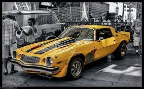 Bumblebee is the name of several fictional characters from the various transformers universes. 1977 Chevy Camaro Photograph Transformers Bumble Bee 1 By Tommy Anderson Transformers Cars Camaro Yellow Camaro