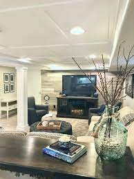 A Hgtv Fixer Upper Basement Remodel With Shiplap Wood Walls Sliding Barn Doors And Industrial Chic Ac Basement Remodeling Cool Basement Ideas Modern Basement