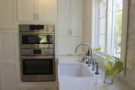 White kitchens with black cabinets on the island boast the room with a marble countertop. How To Choose The Right White Quartz For Kitchen Countertops Hello Lovely