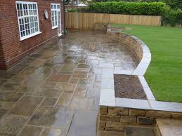 Back Garden And Patio In Dulwich With Reclaimed Yorkstone Paving Retaining Wall And Lawn Patio Landscaping Sloped Backyard Patio Garden