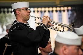 Musician 2nd Class Steven Del Ross, assigned to U.S. Navy Band Southeast,  plays taps during a