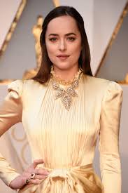 Her pale gold silk gucci dress was giving off major vintage vibes with is high, ruffled collar, long sleeves and pouffy shoulders. Dakota Johnson Says She S Wearing No Makeup To The 2017 Oscars Teen Vogue