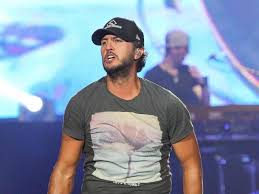 The official music video for luke bryan's play it again she was sittin' all alone over on the tailgate tan legs swingin' by a georgia plate i was lookin' for her boyfriend thinkin', no way she ain't got one soon as i sat down i was fallin' in love tryin' to pour a little sugar in her dixie cup. Play It Again Country Star Luke Bryan Rocks Raleigh Out And About At Wral Com