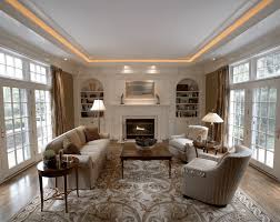 In this living room, an overhead fixture with warm colored light bulbs is augmented with wall sconces hung throughout the room to add an even glow and complement the warm wood accents. Ceiling Light Design For Dining Room Novocom Top