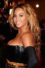 Beuayt black woman with a huge afro hair having fun smiling and touching her hair. How To Choose The Right Hair Color For Black Women Women Hairstyles