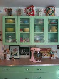 The countertops are glossy gray quartz. 6 Ideas From Karen S Retro Kitchen Remodel Including Pink Terrazzo Countertops Retro Kitchen Retro Kitchen Remodel Kitschy Kitchen