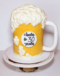 Yellow beer mug cake with white buttercream foam and a Cheers to 30 Years message