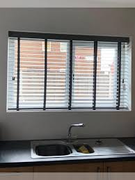 Water resistant roller blinds, aluminium venetians plus faux wooden blinds. Kitchen Blinds