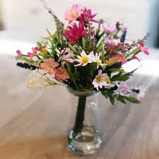 To help you create a lovely centrepiece with ease, our artificial flowers in a vase are ready for placing at the centre of your dining room table. Artificial Flowers In A Vase Arrangement Wildflowers And Pink Daisies