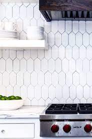 A popular kitchen trend includes hexagon backsplashes with grout that contrasts with the color of the tile. White Hexagon Tile Kitchen Backsplash Novocom Top