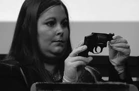 Emergency services personnel assist a toddler, the survivor of a  murder–suicide in a military housing complex, California, Dec