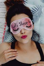 joyful girl relaxing in bedroom top view of brunette women in pink sleeping mask cute sleep mask sleep mask overnight face mask
