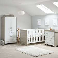 A lovely copper wire pendant light illuminates this charming nursery featuring a round chair and white crib with a peach a tree and bird wall sticker sets a cute backdrop to the white crib in this nursery showcasing a shaggy area rug and open shelving filled with frames. Obaby Nika Cot Bed 3 Piece Nursery Furniture Set Obaby Cuckooland