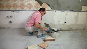 Now you can create a gorgeous accent wall with pergo laminate flooring! Man Applying Ceramic Tile To Stock Footage Video 100 Royalty Free 1550182 Shutterstock