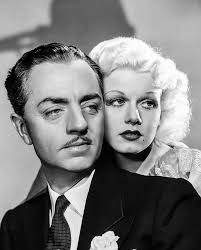 Jean Harlow with a cigarette and drink in hand photographed