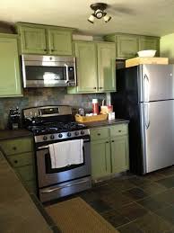 Sage Green Kitchen Cabinets With Black Appliances Green Kitchen Cabinets Green Country Kitchen Dark Green Kitchen