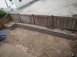 I am a big fan of espoma products so i've always used plant tone (buy on amazon) to fertilize my arborvitae. Trees In Narrow Space Behind Retaining Wall Gardening Landscaping Stack Exchange