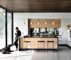 Exposed timber beams are paired with white painted brick walls and polished concrete flooring. A Modern Industrial Style Home With A Heart
