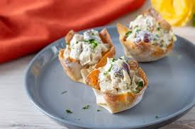 Press one wonton wrapper into each muffin cup, and liberally spray the tops and sides of the wonton wrappers with additional cooking spray. Chicken Salad Wonton Cups Stetted