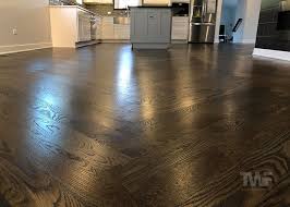 The beautiful dark wood floors continue all throughout the main floor of this home, allowing the various seating areas to flow into one another through the wide archways. Thinking Of Staining Your Hardwood Floors A Dark Color