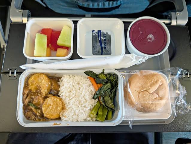 Upgraded meal service served with proper tableware and signature garlic bread.