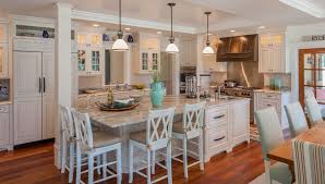 The black granite counters look beautiful on both center island and peninsula. White Kitchen With Beautiful Dining Island Celebrate Decorate