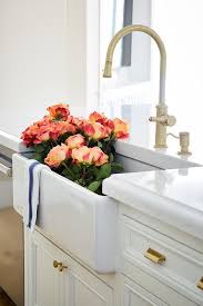 farmhouse kitchen sink with brass