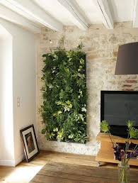 Vertical garden decor is not only limited to small spaces but you can also hang vertical planters or establish vertical gardens in your spacy gardens to fill space and decorate them. Stone Wall Interior Design Ideas Interior Vertical Garden Living Room Decor Green Walls Vertical Garden Indoor