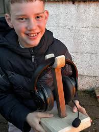 My 11 year old son with his first self made ukulele. (I only helped with  the rootings and the paint)