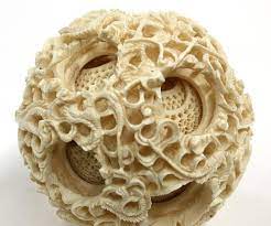 This is carved in ivory and dating from the late c19th. Chinese Ivory Puzzle Ball Elephant Stand