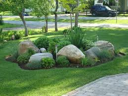 If there is a path that receives a lot of foot traffic on your property, make a path using the crushed rock. Mix Landscape Bed With Large Rocks Large Yard Landscaping Rock Garden Landscaping Rock Garden Design