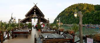 The trained personnel of the crocodile farm will go into the pond with a bucket of fishes on his hand. Langkawi Fish Farm Restaurant Bangsar Babe