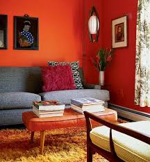 Curtains and walls are also white, while patterns accent the floor rug, throw pillows and the ceiling. Mid Century Living Room With Orange Walls Living Room Decor Orange Living Room Orange Orange Living Room Walls
