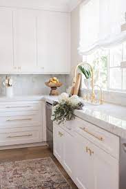 The light wood floors, white cabinets and white waterfall countertop keep the space feeling airy and bright. Kitchen Gallery I Option 2 White Kitchen Design Kitchen Design Home Kitchens