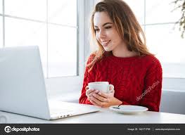 Image result for Happy woman using laptop at café