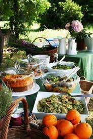 A rustic table setting with colorful bloom and greenery centerpieces and an uncovered table. Rustic Buffet Table Setting Google Search Brunch Buffet Outdoor Brunch Outdoor Brunch Party