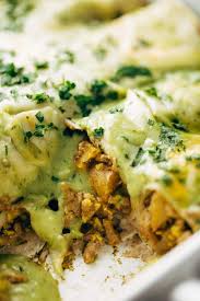 The enchiladas are topped with a tangy and bright tomatillo sauce and sprinkled with cheese before baking. Breakfast Enchiladas With Roasted Poblano Sauce Recipe Pinch Of Yum