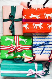 Pick up the top point of the wrapping paper and fold it down on top. 3 Ways To Wrap Gifts In Fabric Learn 3 Easy Ways To Wrap Gifts In Fabric That Require No Sewing Use Holiday Fabric For Festive Gift Wrapping Or Utilize These Techniques