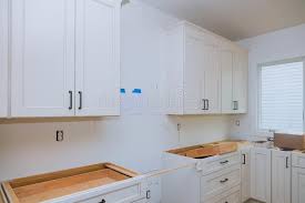 To stunning examples of white cabinets; White Of Kitchen Wooden Cabinets With Contemporary Stock Photo Image Of Furniture Installing 158895184