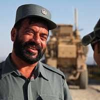 An Afghan Uniform Police chief speaks to an interpreter