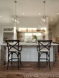 Classic café walnut bar & counter stools. Restoration Hardware Madeleine Counter Stool Arteriors Reeves Pendant Shiplap Paneled Stove Hood Flo Veranda Interiors Stained Kitchen Cabinets Floor Colors